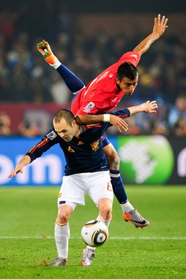 Andres Iniesta and Arturo Vidal battle