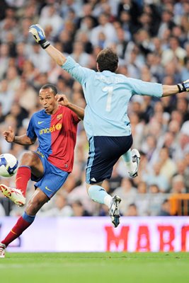 Casillas of Real Madrid blocks Thierry Henry of Barcelona