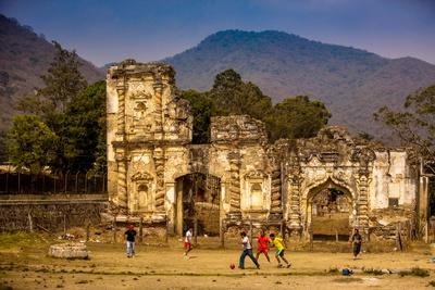 Kids Playing Soccer at Antigua Ruins — Guatemala Poster