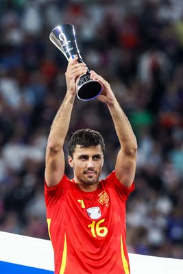 Rodri Spain celebrates with Player of the Tournament trophy Berlin EURO 2024